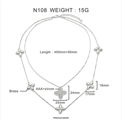 Double collier modèle de trèfle parsemé de pierres de zircone, plaqué rhodium.